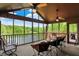 Relaxing screened porch with ceiling fans, comfortable seating, and a beautiful lake view at 5571 Poff Rd, Martinsville, IN 46151
