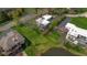 Aerial view of a home with a large yard, a serene lake, and mature trees creating a peaceful setting at 601 Terrace Lake Dr, Columbus, IN 47201