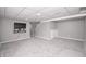 Finished basement with entertainment center, neutral walls, and carpet for versatile use at 601 Terrace Lake Dr, Columbus, IN 47201