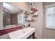 Modern bathroom featuring a red tiled accent wall, shelving, and sleek fixtures at 601 Terrace Lake Dr, Columbus, IN 47201