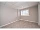 Bedroom with neutral colored walls, carpet, and a window at 601 Terrace Lake Dr, Columbus, IN 47201