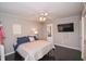The bright bedroom includes a ceiling fan, large window and mounted TV at 601 Terrace Lake Dr, Columbus, IN 47201