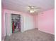 Bright bedroom with a large closet, neutral carpet, and ceiling fan, perfect for storage at 601 Terrace Lake Dr, Columbus, IN 47201
