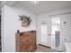 Bright entryway with a wood cabinet for storage with an outside view through a glass door that provides ample natural light at 601 Terrace Lake Dr, Columbus, IN 47201