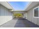 Covered entryway showcasing a spacious gray wood deck and a view of lush greenery at 601 Terrace Lake Dr, Columbus, IN 47201