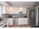 Updated kitchen with stainless appliances, white cabinets, granite countertops, and a stylish backsplash at 601 Terrace Lake Dr, Columbus, IN 47201
