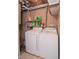Basement laundry room with side-by-side washer and dryer and shelving for storage at 601 Terrace Lake Dr, Columbus, IN 47201