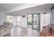 Bright living room featuring a slider to the backyard deck, comfortable seating, and wood flooring at 601 Terrace Lake Dr, Columbus, IN 47201