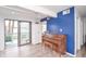 Bright living room with light floors, piano and sliding door to backyard deck at 601 Terrace Lake Dr, Columbus, IN 47201