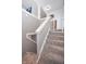 Carpeted stairway with neutral gray walls and white trim at 601 Terrace Lake Dr, Columbus, IN 47201