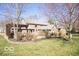 Expansive backyard with a wooden deck, mature trees, and lush green grass at 6019 Timberbend Dr, Avon, IN 46123