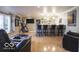 Finished basement with a custom bar, hardwood floors, and a comfortable seating area at 6019 Timberbend Dr, Avon, IN 46123