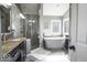 Elegant bathroom with a soaking tub, a glass-enclosed shower, and a granite-topped vanity at 6019 Timberbend Dr, Avon, IN 46123