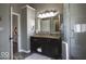 Modern bathroom features a vanity with granite countertop, a large mirror, and glass-enclosed shower at 6019 Timberbend Dr, Avon, IN 46123