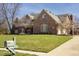 Traditional brick home with a well-manicured lawn, mature trees, and a charming mailbox at 6019 Timberbend Dr, Avon, IN 46123