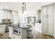 Well-lit kitchen with white cabinets, a granite island, and stainless steel appliances at 6019 Timberbend Dr, Avon, IN 46123
