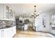 Spacious kitchen with hardwood floors, white cabinets, island, and ample counter space at 6019 Timberbend Dr, Avon, IN 46123