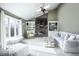 Bright living room with vaulted ceilings, a brick fireplace, and built-in bookshelves at 6019 Timberbend Dr, Avon, IN 46123