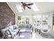 Bright sunroom with brick accent wall, skylights, and comfortable seating at 6019 Timberbend Dr, Avon, IN 46123