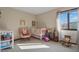 Charming Bedroom with a crib, pink rocking chair, and natural light creating a peaceful environment at 6140 Buttonwood Dr, Noblesville, IN 46062