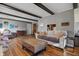 Bright living room with laminate flooring, wooden beams, and comfortable seating at 6140 Buttonwood Dr, Noblesville, IN 46062