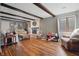 Spacious living room with wood floors, fireplace, neutral furniture, and ample natural light at 6140 Buttonwood Dr, Noblesville, IN 46062