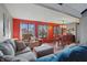 Comfortable living room with plush seating, red accent wall, and hardwood floors at 6140 Buttonwood Dr, Noblesville, IN 46062