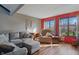Cozy living room featuring hardwood floors, gray sofa, and natural light at 6140 Buttonwood Dr, Noblesville, IN 46062
