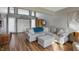 Bright living area with high ceilings, hardwood floors, and comfortable gray sofa at 6140 Buttonwood Dr, Noblesville, IN 46062