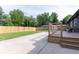 An expansive backyard with a stained wood deck, concrete patio and privacy fence at 6555 Michigan Rd, Indianapolis, IN 46268