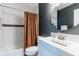 Bathroom featuring a subway tile shower and modern vanity with a round mirror at 6555 Michigan Rd, Indianapolis, IN 46268