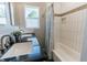 Bathroom boasting a dual sink vanity with black countertops and tiled shower at 6555 Michigan Rd, Indianapolis, IN 46268