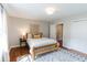 Bedroom showcasing a wooden bed frame, hardwood floors and decorative rug at 6555 Michigan Rd, Indianapolis, IN 46268
