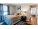 Bedroom featuring a queen size bed, wood floors, and large window at 6555 Michigan Rd, Indianapolis, IN 46268