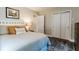 Bedroom featuring a queen size bed, wood floors, and closets at 6555 Michigan Rd, Indianapolis, IN 46268
