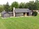 Beautifully renovated one-story home with a lush green lawn and dark siding at 6555 Michigan Rd, Indianapolis, IN 46268