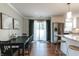 Open kitchen and dining area with stainless steel fridge and light wood floors at 6555 Michigan Rd, Indianapolis, IN 46268