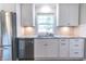 Beautiful kitchen featuring stainless steel appliances, white cabinets, and a subway tile backsplash at 6555 Michigan Rd, Indianapolis, IN 46268