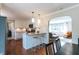 Modern kitchen with white cabinets and stainless steel appliances opening up to the living room at 6555 Michigan Rd, Indianapolis, IN 46268