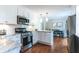 Modern kitchen with white cabinets, subway tile backsplash, and stainless steel appliances at 6555 Michigan Rd, Indianapolis, IN 46268