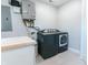 Laundry room equipped with modern washer, dryer, and butcher block folding table at 6555 Michigan Rd, Indianapolis, IN 46268