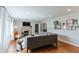 Open concept living room featuring hardwood floors, modern fireplace and unique wall art at 6555 Michigan Rd, Indianapolis, IN 46268