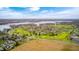 Scenic aerial shot capturing a vibrant community, a golf course, and a beautiful lake in the distance at 7002 Oakbay Cir, Noblesville, IN 46062