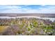 Panoramic aerial view of a charming lakeside community with beautiful homes surrounded by lush greenery and scenic waterfront at 7002 Oakbay Cir, Noblesville, IN 46062
