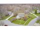 Wide aerial shot of a traditional home featuring green lawn and blooming trees at 7002 Oakbay Cir, Noblesville, IN 46062