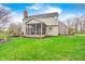 The backyard features an inviting porch, deck, and lush lawn, perfect for outdoor entertaining and relaxation at 7002 Oakbay Cir, Noblesville, IN 46062