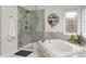 Bathroom featuring a standalone shower, bathtub, natural light, and neutral colors at 7002 Oakbay Cir, Noblesville, IN 46062