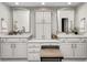Bright bathroom featuring a double vanity with white cabinets and an upholstered bench at 7002 Oakbay Cir, Noblesville, IN 46062