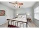 Comfortable bedroom with a ceiling fan, side tables and lamps, and closet access at 7002 Oakbay Cir, Noblesville, IN 46062