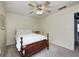 A simple bedroom with a wood bed frame, carpeted floor, and ceiling fan at 7002 Oakbay Cir, Noblesville, IN 46062
